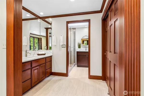 a view of hallway with cabinets and wooden floor
