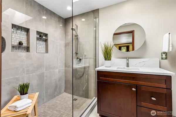 a bathroom with a sink vanity granite and a mirror