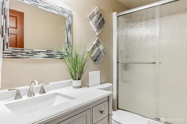 a bathroom with a sink a mirror and a shower
