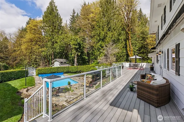 a view of a balcony with wooden floor and outdoor seating