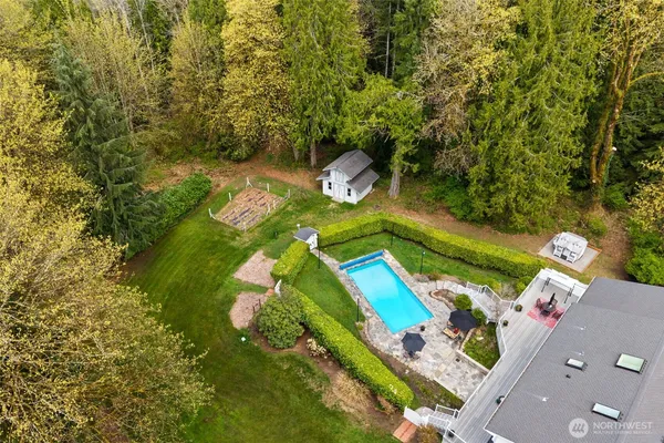 an aerial view of a house with a yard basket ball court