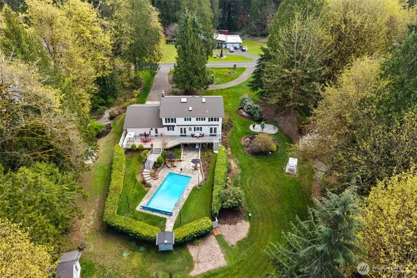 an aerial view of a house with a swimming pool