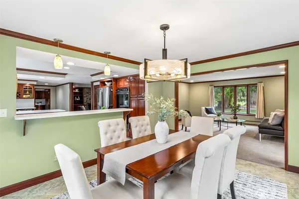 a view of a dining room with furniture window and outside view