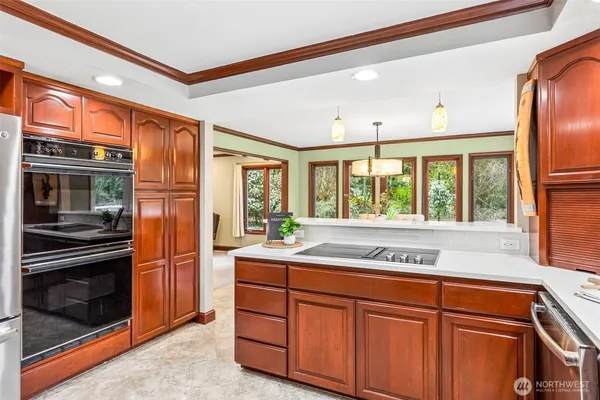 a kitchen with stainless steel appliances sink stove and refrigerator