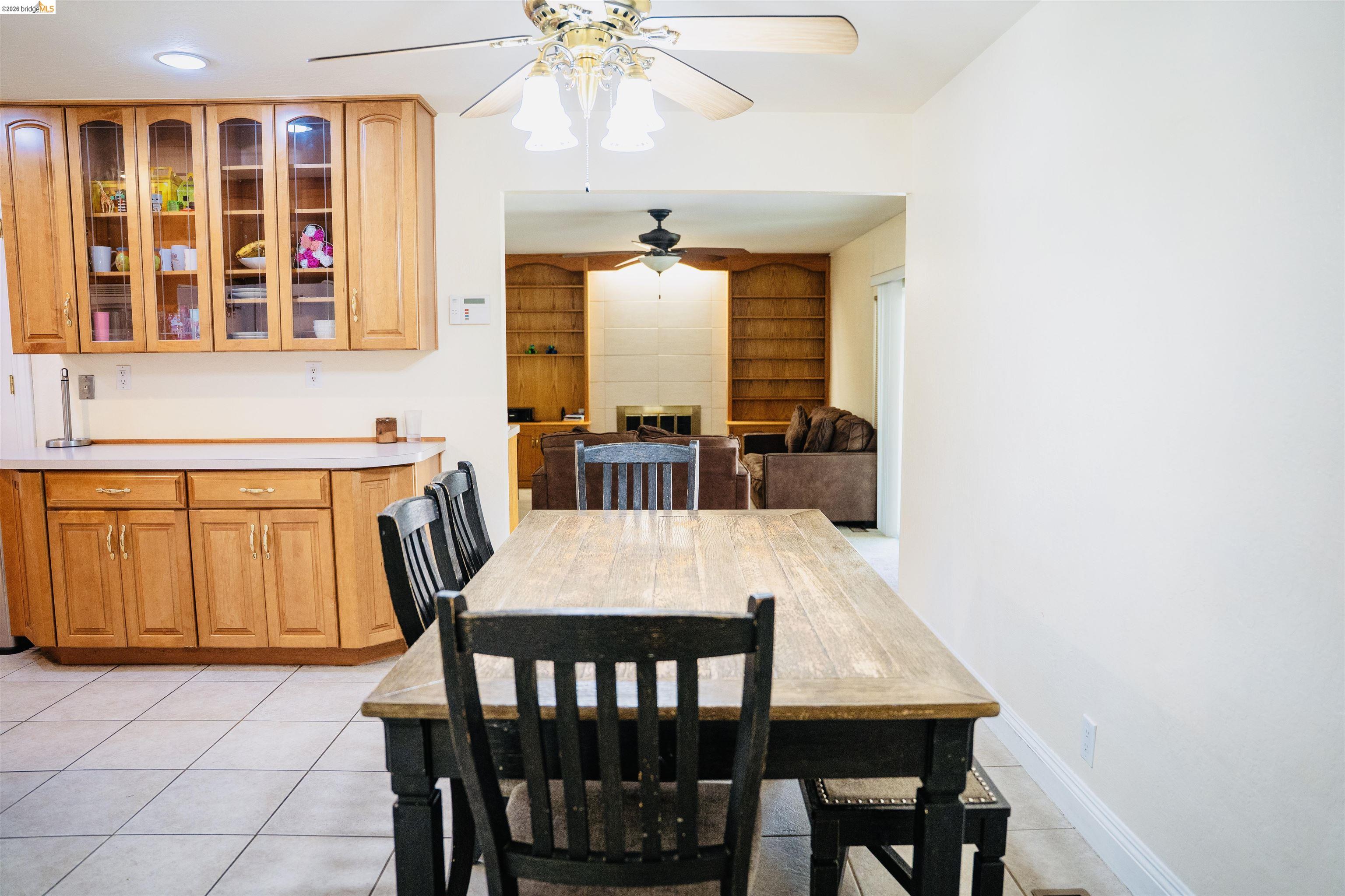 3513 Rio Grande Drive Antioch, CA 94509 - Photo 11 of 22 Kitchen and dining area featuring wood-finish cabinetry, tile flooring, and a ceiling fan