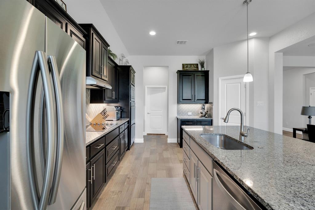 5642 Ranger Drive Midlothian, TX 76065 - Photo 12 of 40 a kitchen with stainless steel appliances granite countertop a sink refrigerator and cabinets