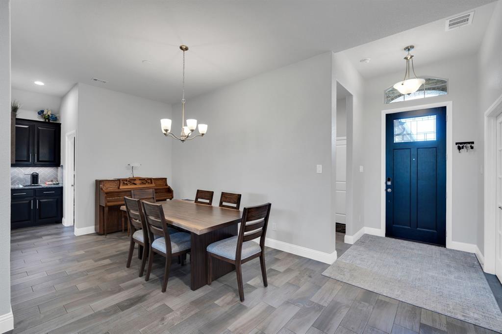 5642 Ranger Drive Midlothian, TX 76065 - Photo 16 of 40 a view of a dining room with furniture window and wooden floor