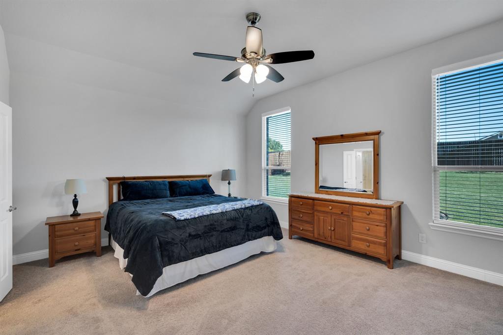 5642 Ranger Drive Midlothian, TX 76065 - Photo 20 of 40 a bedroom with a bed lamp and a large window