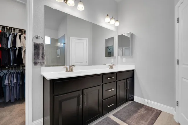 a bathroom with a glass shower door