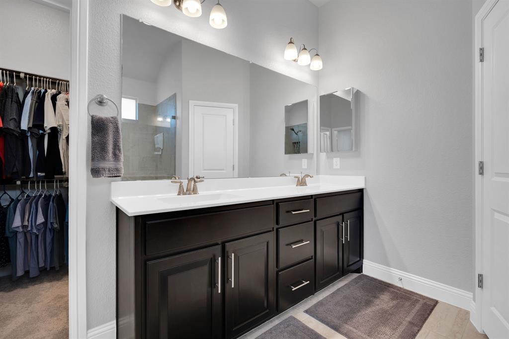 5642 Ranger Drive Midlothian, TX 76065 - Photo 24 of 40 a bathroom with a double vanity sink and a mirror