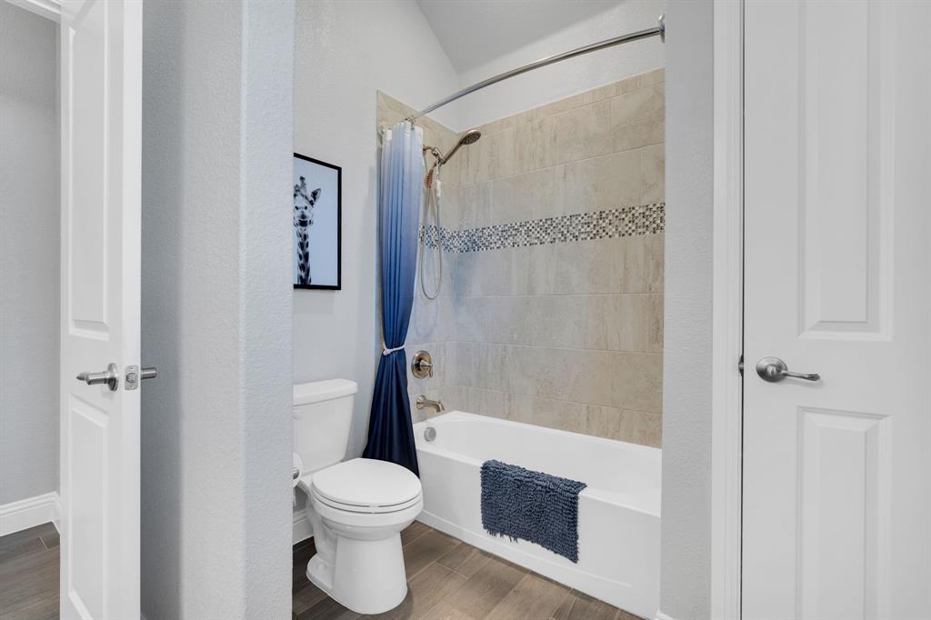 5642 Ranger Drive Midlothian, TX 76065 - Photo 29 of 40 a bathroom with a toilet and a shower