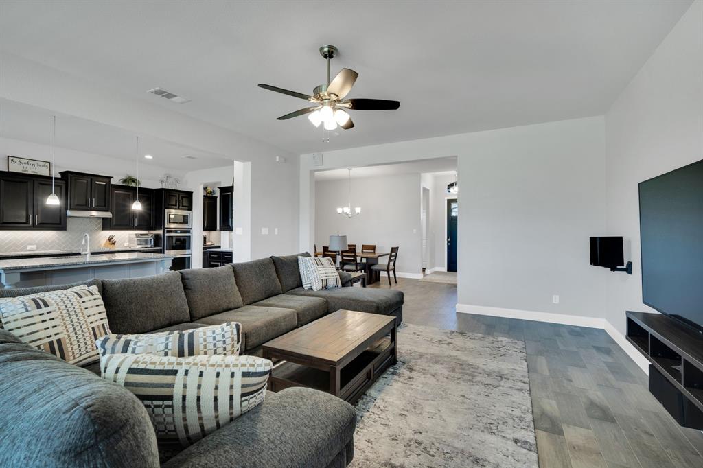 5642 Ranger Drive Midlothian, TX 76065 - Photo 5 of 40 a living room with furniture and a flat screen tv