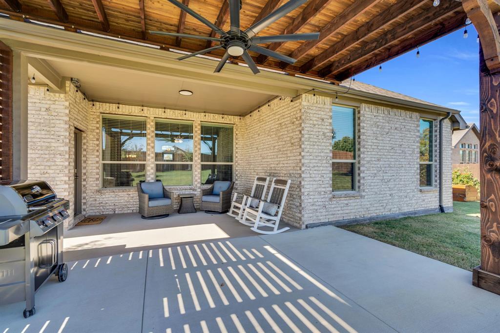 5642 Ranger Drive Midlothian, TX 76065 - Photo 7 of 40 a view of a patio with table and chairs with wooden floor and fence