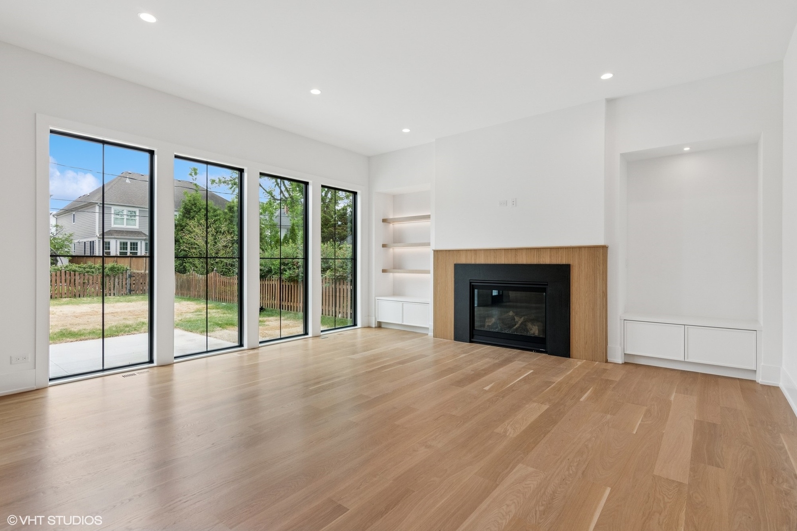 613 Chatham Avenue Elmhurst, IL 60126 - Photo 13 of 37 a view of an empty room with wooden floor and a fireplace