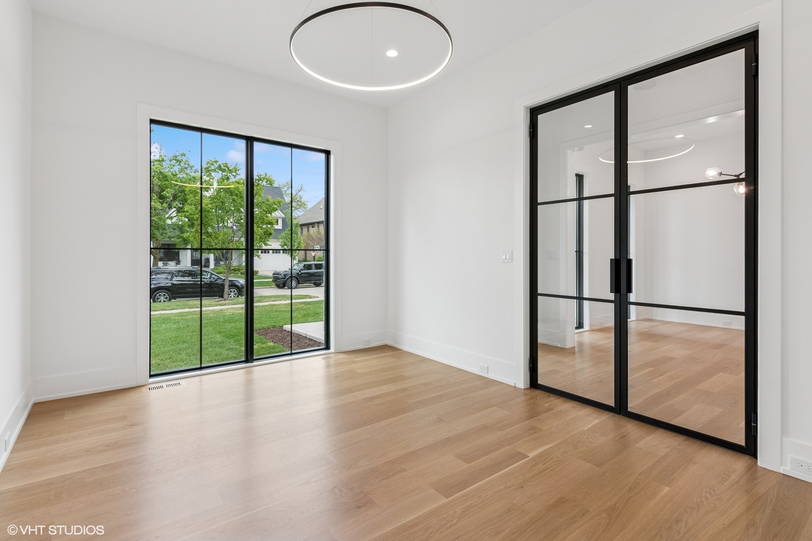 613 Chatham Avenue Elmhurst, IL 60126 - Photo 3 of 37 a view of an empty room with wooden floor and a window