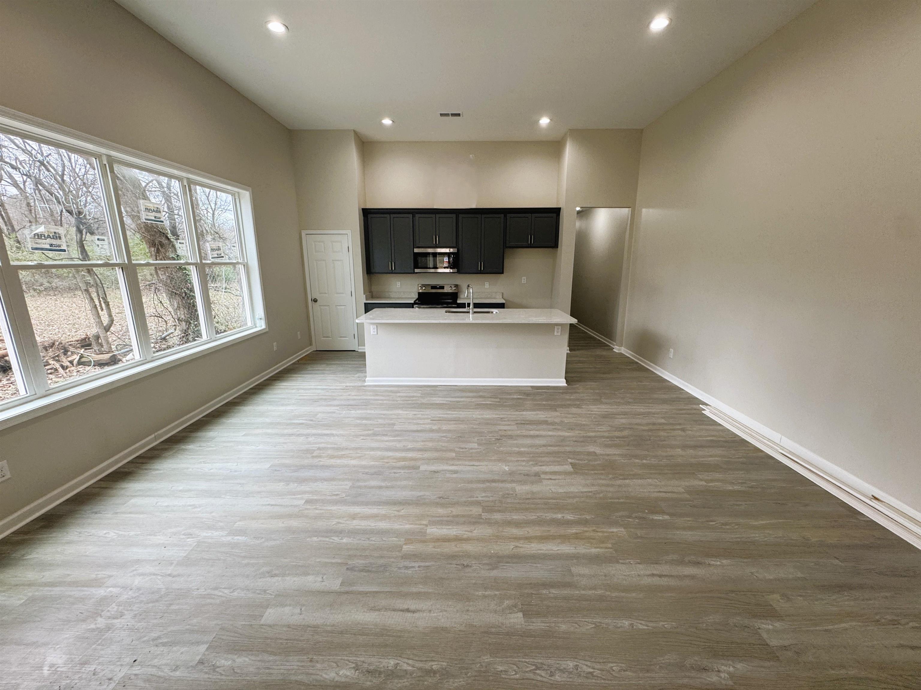 547 Berclair Road, Unit 101 Memphis, TN 38122 - Photo 18 of 19 Kitchen with an island with sink, light wood-style flooring, open floor plan, and recessed lighting