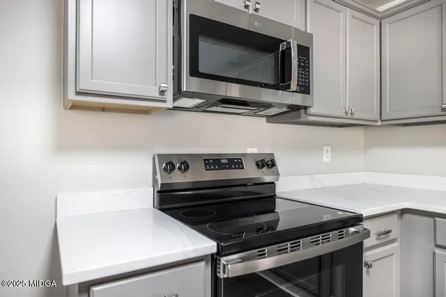 a kitchen with a stove and a microwave