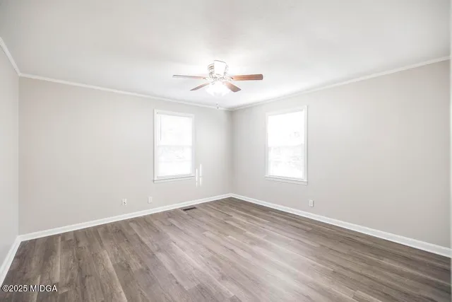 wooden floor in an empty room with a window