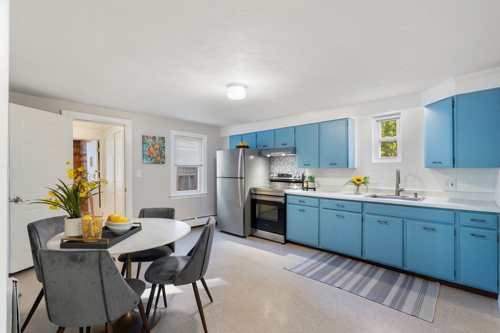 27 Water Street Concord, MA 01742 - Photo 13 of 21 a kitchen with a table and chairs in it