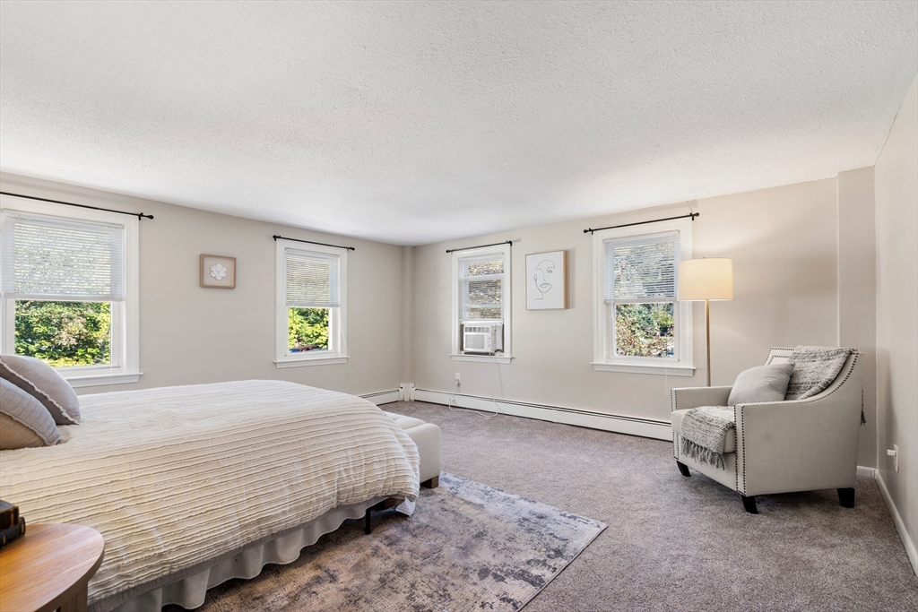 27 Water Street Concord, MA 01742 - Photo 16 of 21 a spacious bedroom with a bed and a couch