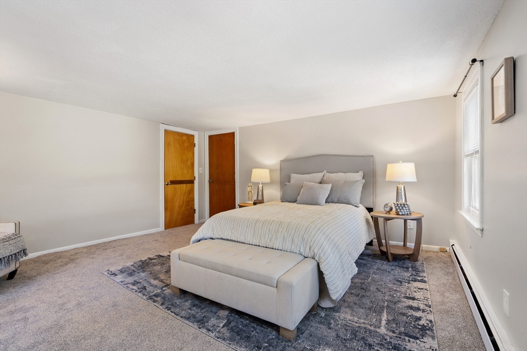 27 Water Street Concord, MA 01742 - Photo 17 of 21 a bedroom with a bed and a lamp with window