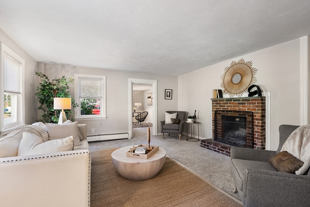 27 Water Street Concord, MA 01742 - Photo 4 of 21 a living room with furniture and a fireplace