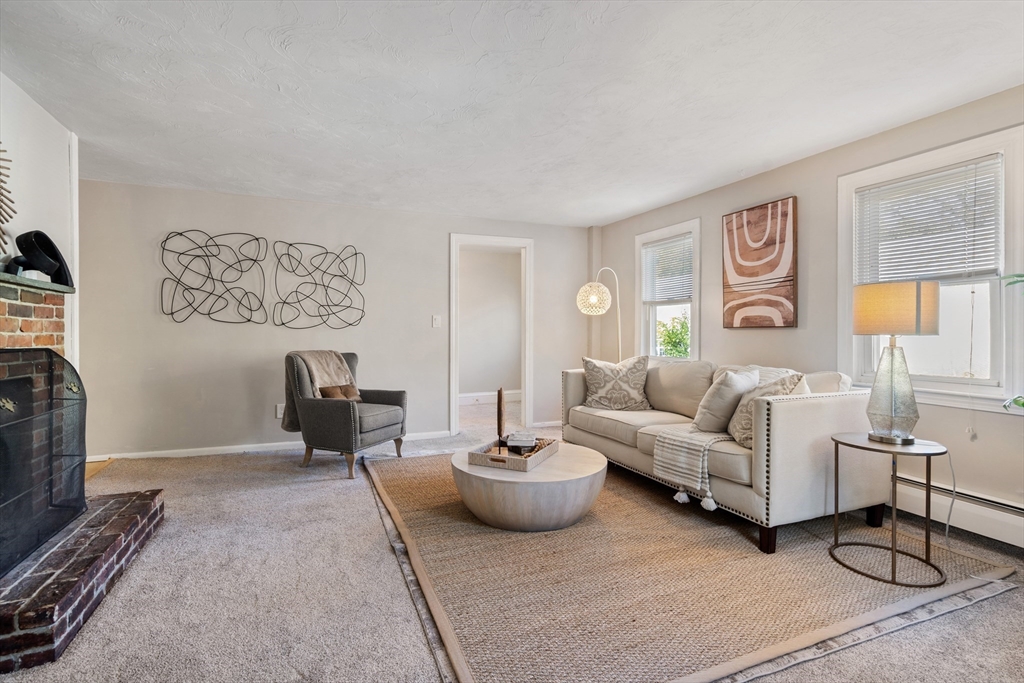 27 Water Street Concord, MA 01742 - Photo 5 of 21 a living room with furniture a window and a flat screen tv