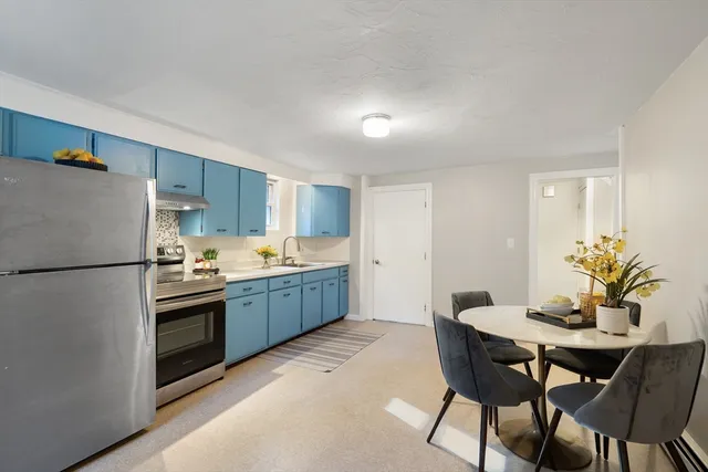 a kitchen with a table and chairs