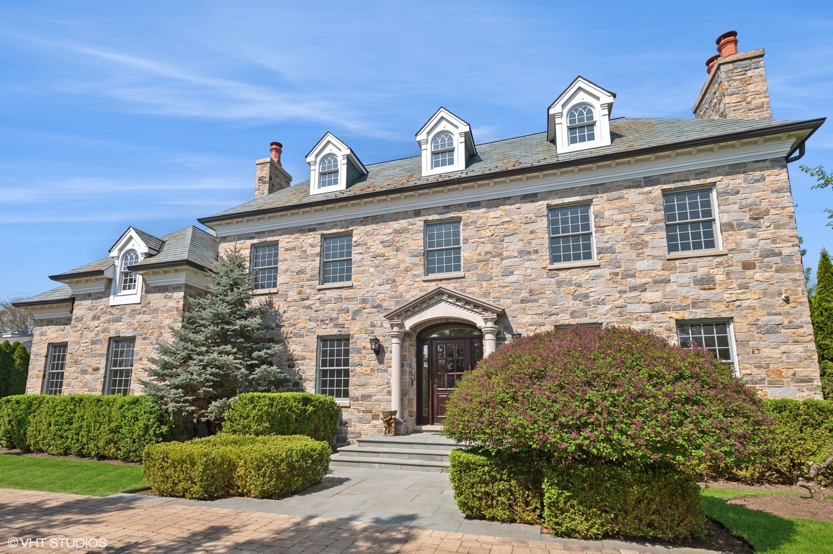 a front view of a house with a garden