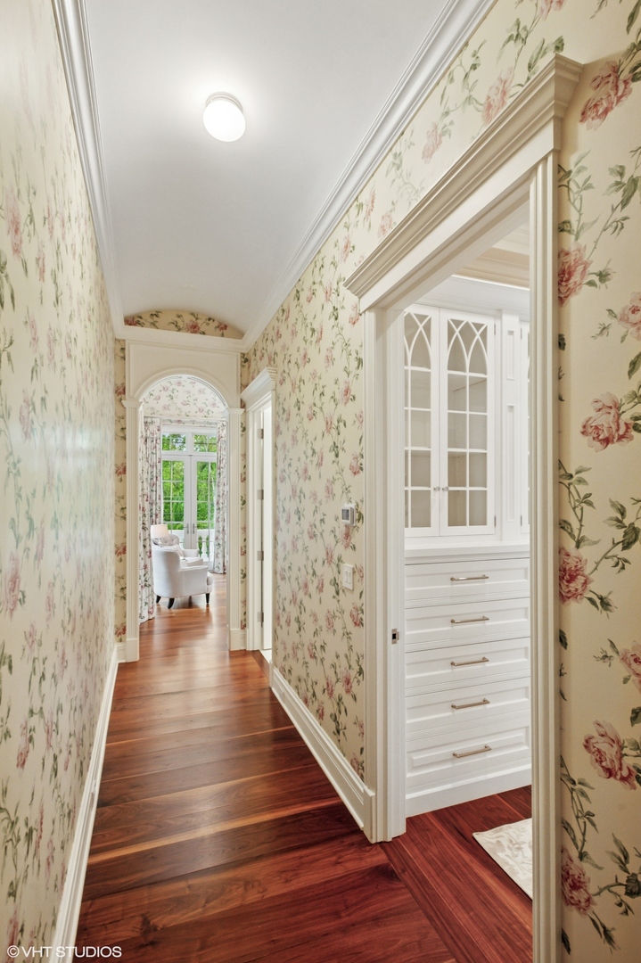 78 Wagner Road Northfield, IL 60093 - Photo 22 of 66 a view of a hallway with wooden floor and staircase