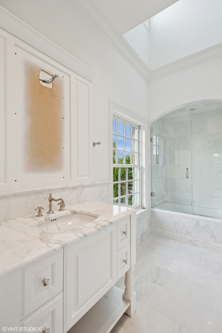 78 Wagner Road Northfield, IL 60093 - Photo 34 of 66 a bathroom with a sink double vanity and a mirror