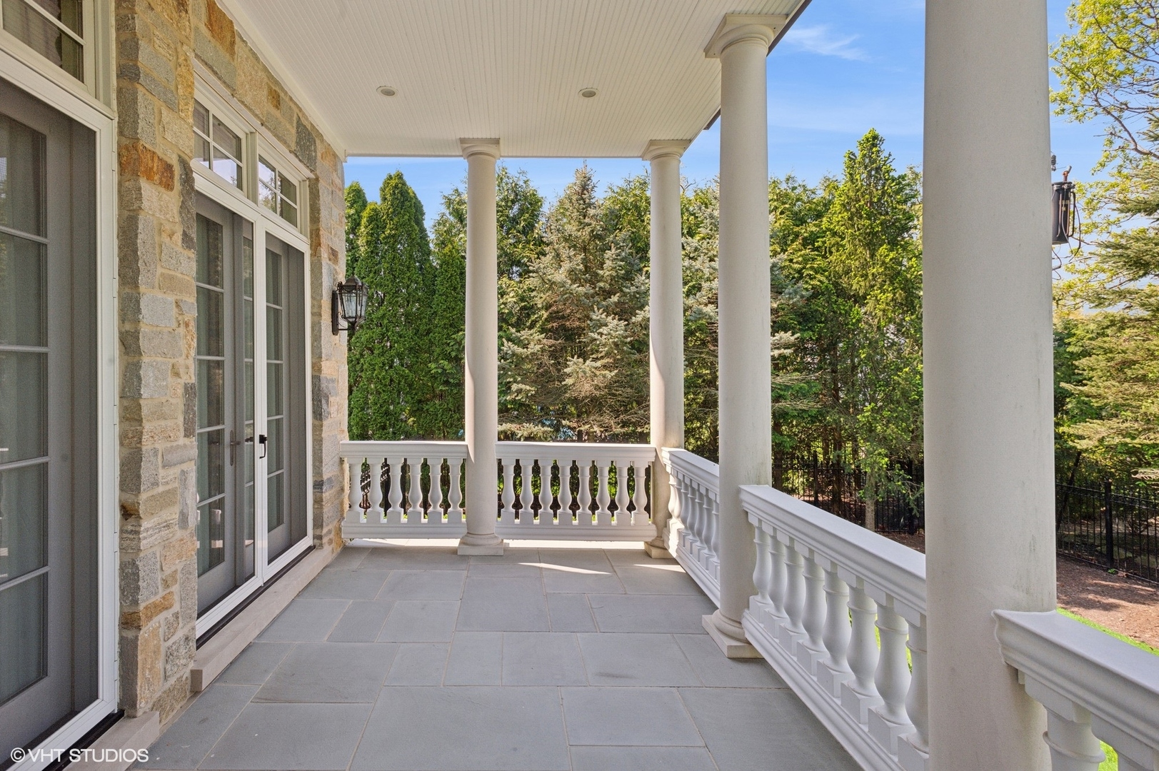 78 Wagner Road Northfield, IL 60093 - Photo 61 of 66 a view of a porch with a floor to ceiling window and wooden fence