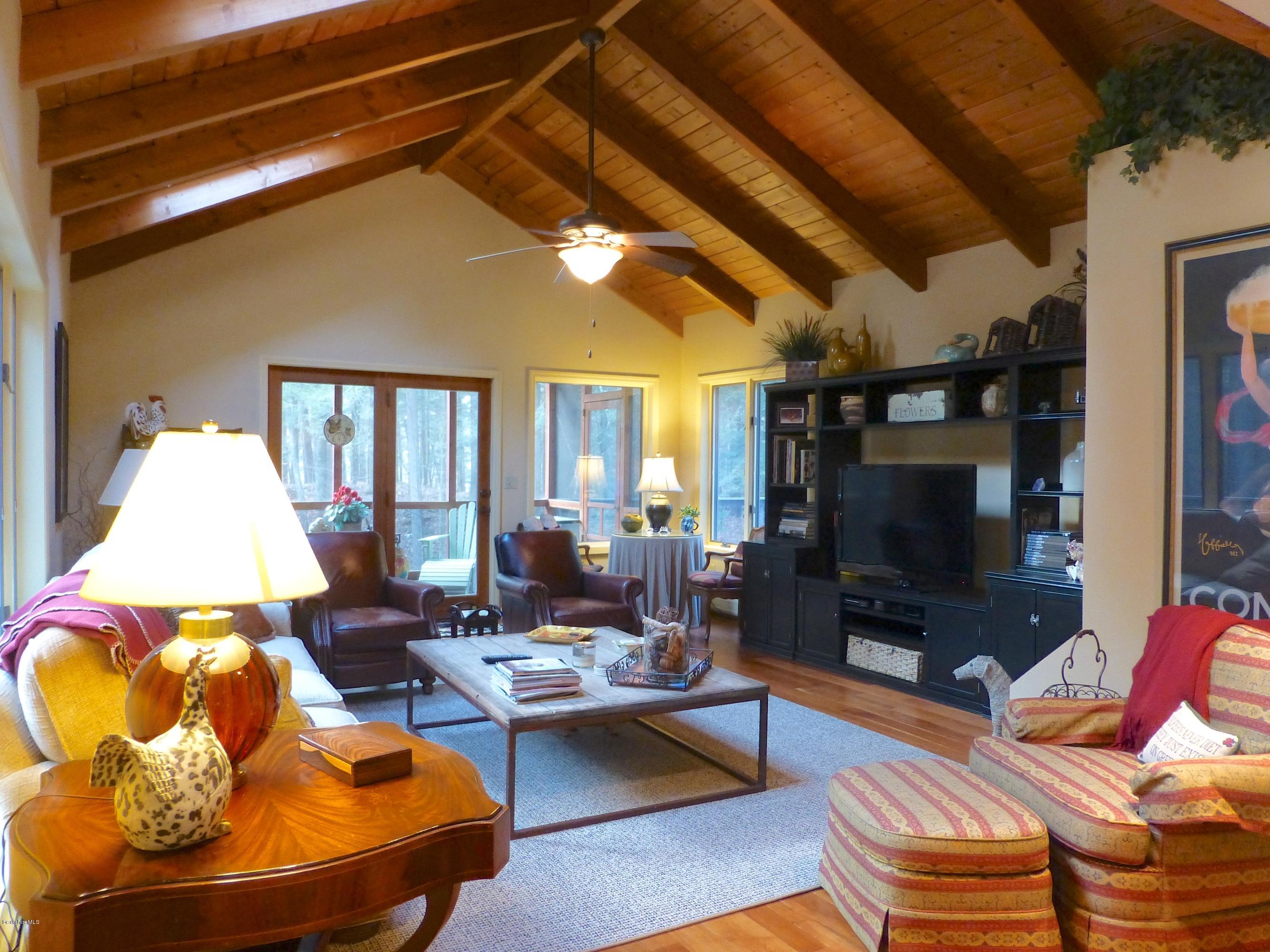 34 Glendale Road Stockbridge, MA 01262 - Photo 2 of 24 a living room with patio furniture and a flat screen tv