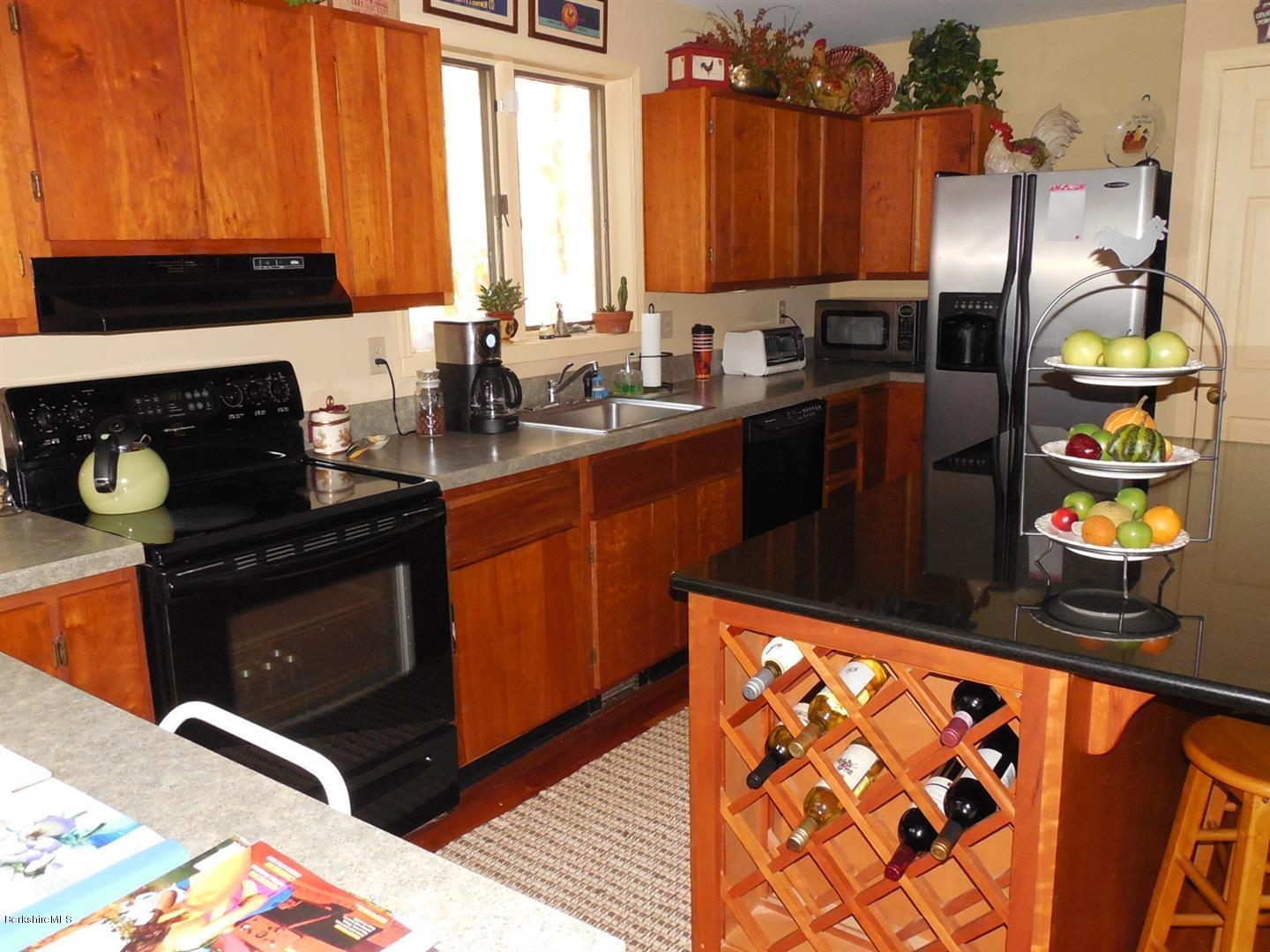 34 Glendale Road Stockbridge, MA 01262 - Photo 13 of 24 a kitchen with stainless steel appliances granite countertop a stove a sink and a microwave