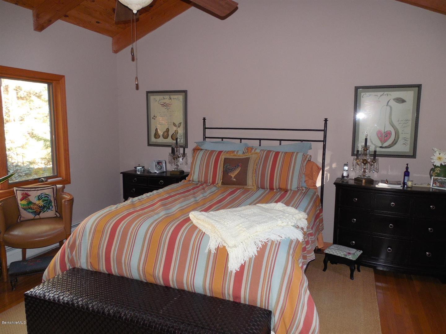 34 Glendale Road Stockbridge, MA 01262 - Photo 15 of 24 a bedroom with a bed and dresser with mirror