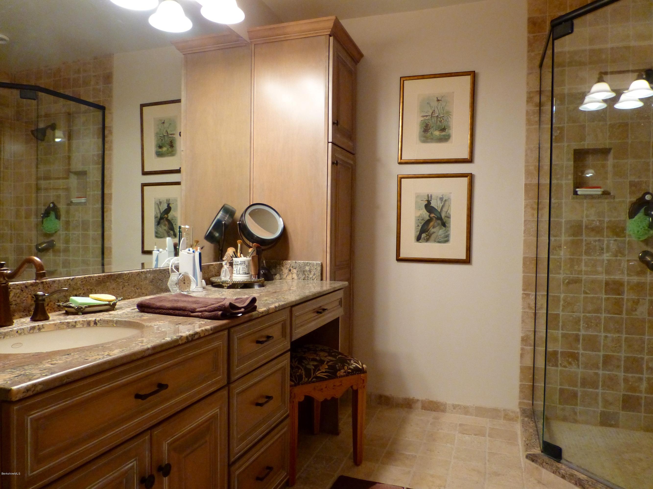 34 Glendale Road Stockbridge, MA 01262 - Photo 16 of 24 a bathroom with a granite countertop sink a mirror and shower