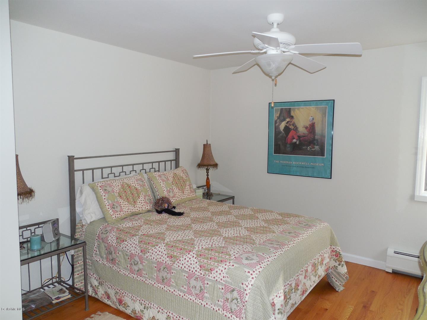 34 Glendale Road Stockbridge, MA 01262 - Photo 17 of 24 a bedroom with a bed and a chandelier