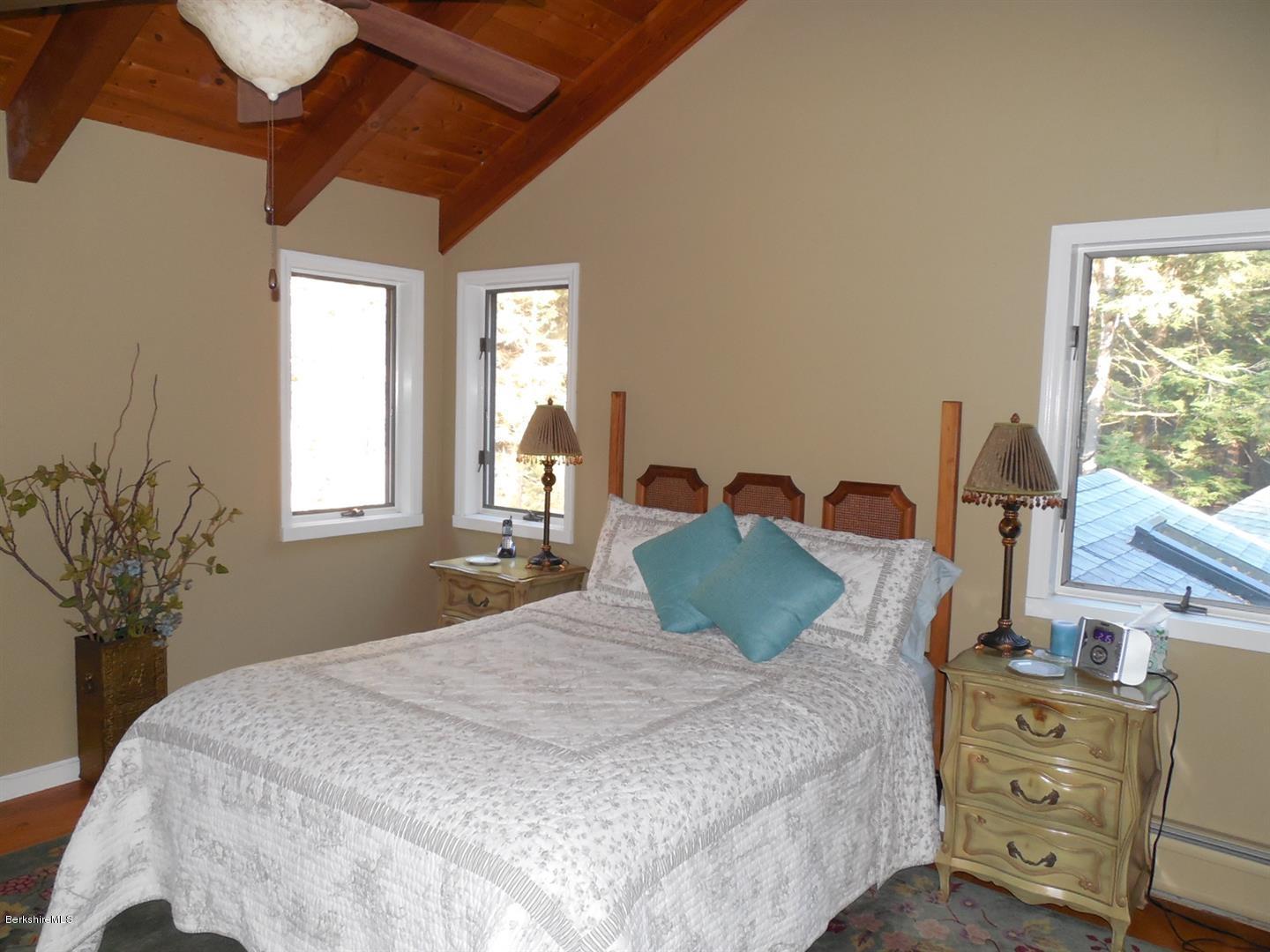 34 Glendale Road Stockbridge, MA 01262 - Photo 18 of 24 a bedroom with a bed and large windows