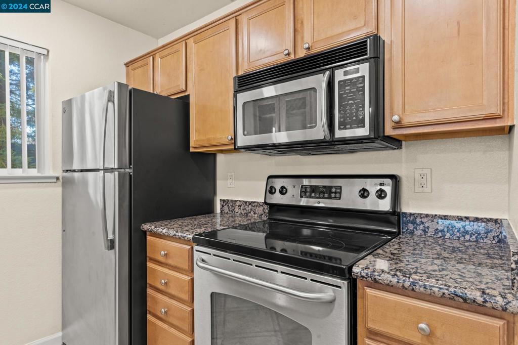 285 Reflections Drive San Ramon, CA 94583 - Photo 11 of 42 a kitchen with stainless steel appliances granite countertop a refrigerator stove and microwave