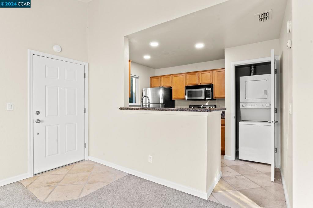 285 Reflections Drive San Ramon, CA 94583 - Photo 14 of 42 a kitchen with stainless steel appliances granite countertop a refrigerator and a stove top oven