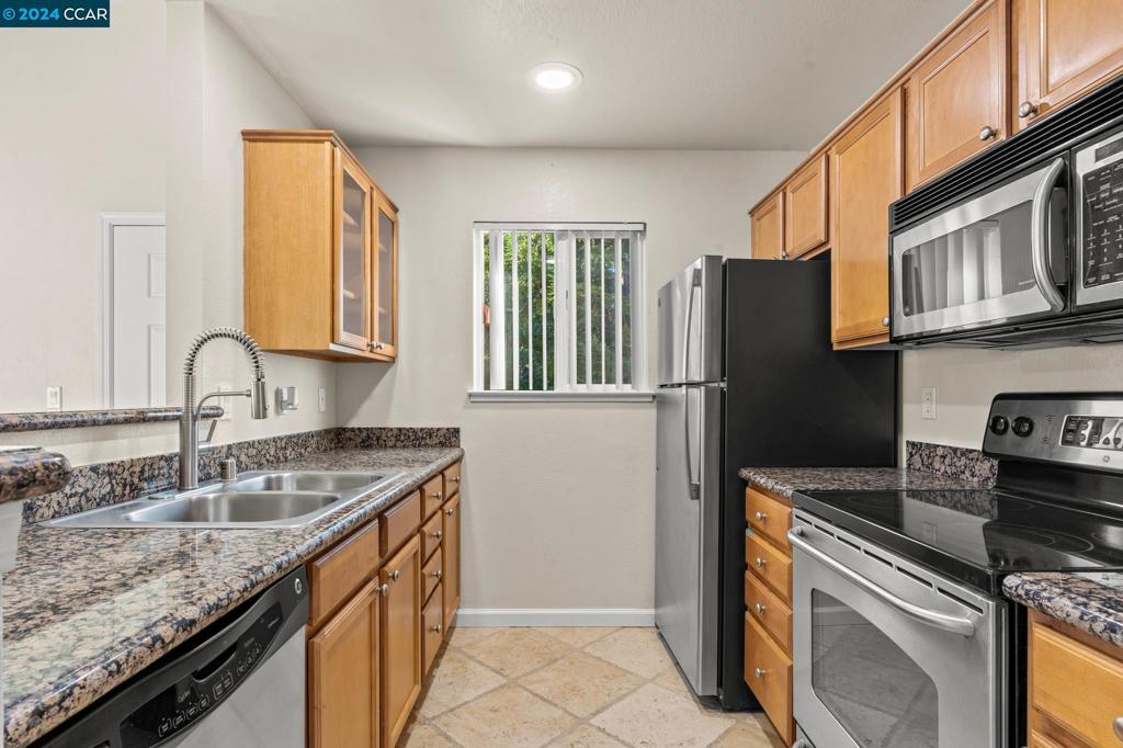 285 Reflections Drive San Ramon, CA 94583 - Photo 9 of 42 a kitchen with granite countertop a sink stove and refrigerator
