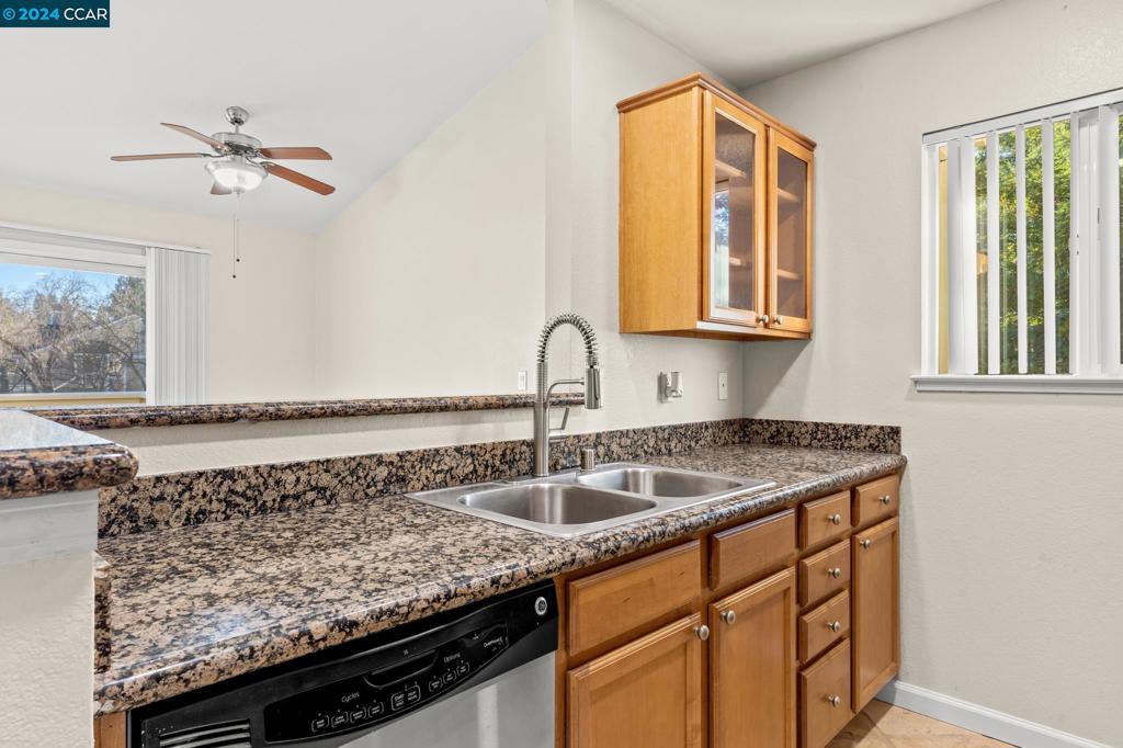 285 Reflections Drive San Ramon, CA 94583 - Photo 10 of 42 a kitchen with a granite countertop sink and cabinets