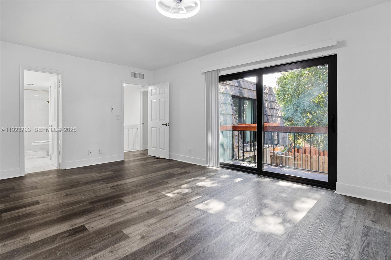 4059 Palm Bay Circle, Unit C West Palm Beach, FL 33406 - Photo 15 of 27 a view of a big room with wooden floor and windows