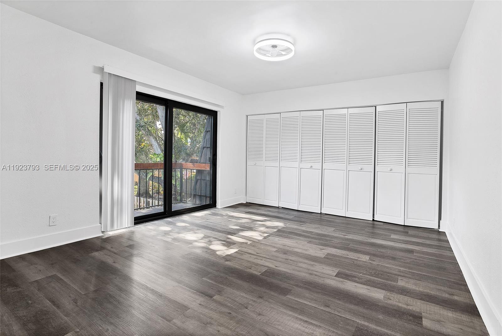 4059 Palm Bay Circle, Unit C West Palm Beach, FL 33406 - Photo 18 of 27 a view of an empty room with wooden floor and a window