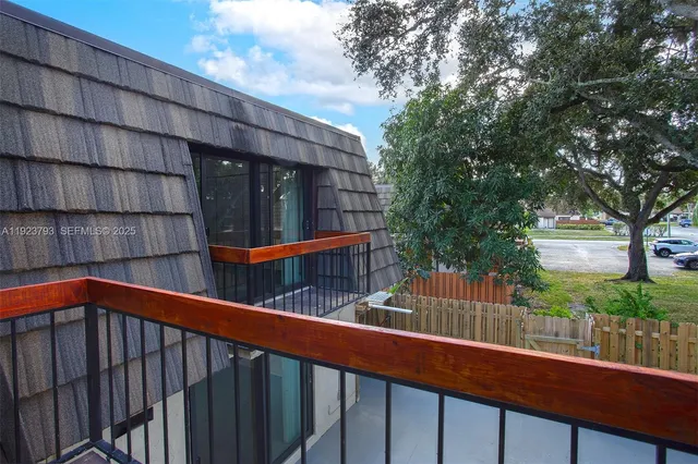 a balcony with trees in front of it