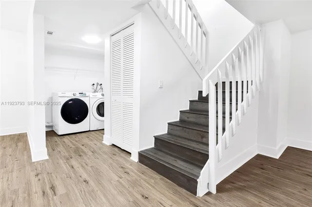 a view of entryway and hall with wooden floor