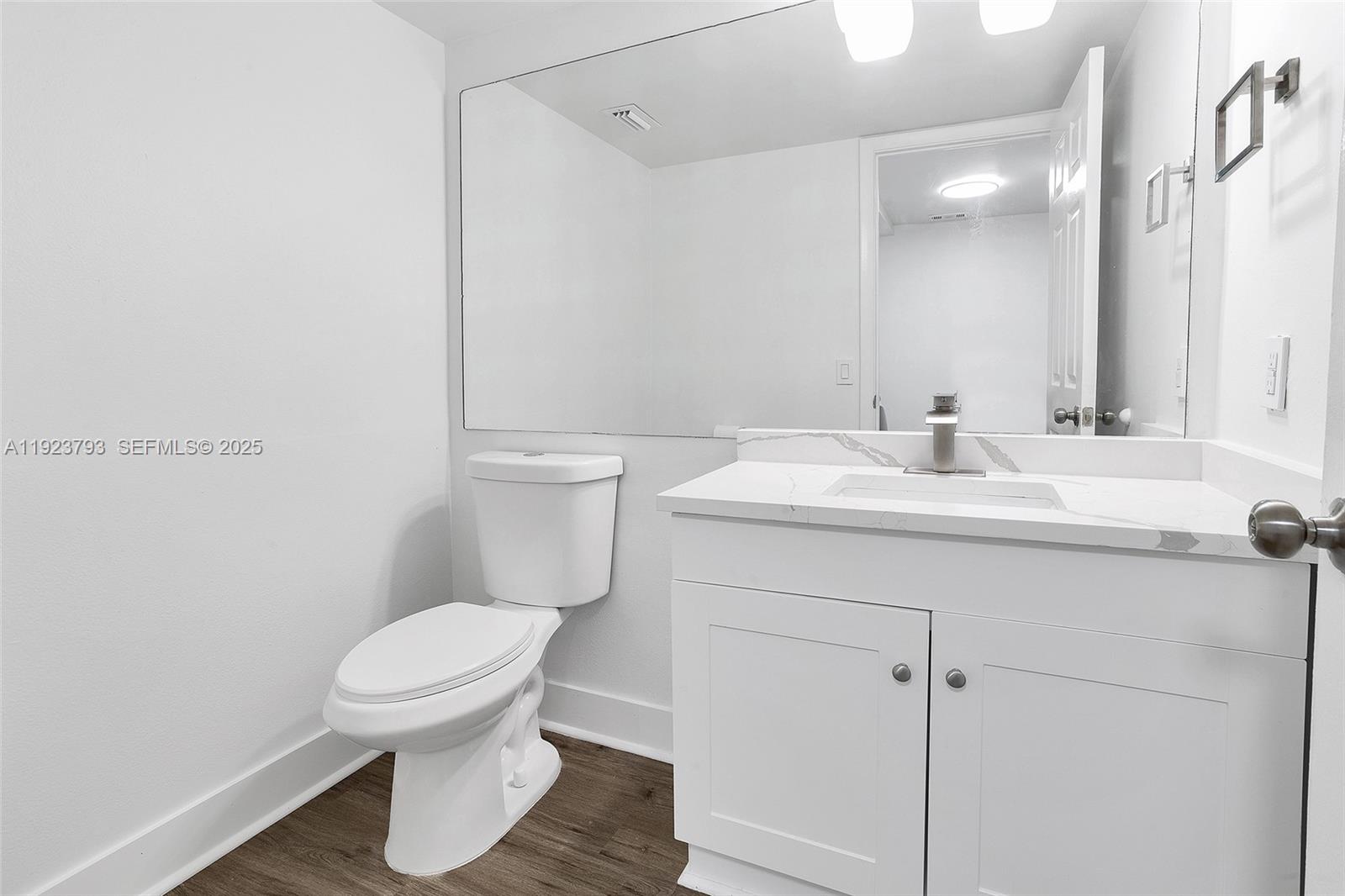 4059 Palm Bay Circle, Unit C West Palm Beach, FL 33406 - Photo 7 of 27 a bathroom with a sink toilet and mirror