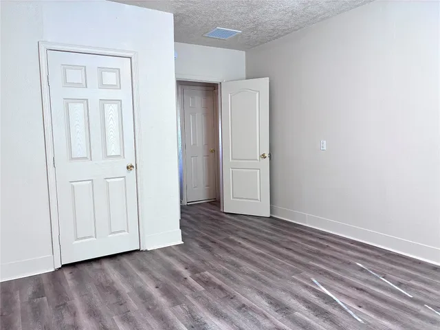 a view of an empty room and wooden floor