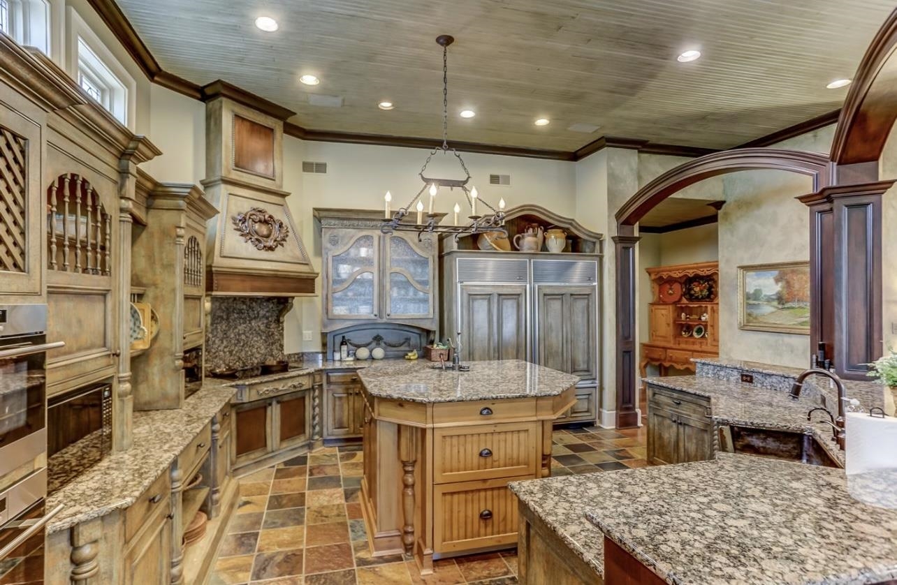 8575 The Island Memphis, TN 38125 - Photo 19 of 40 a kitchen with sink stove and cabinets