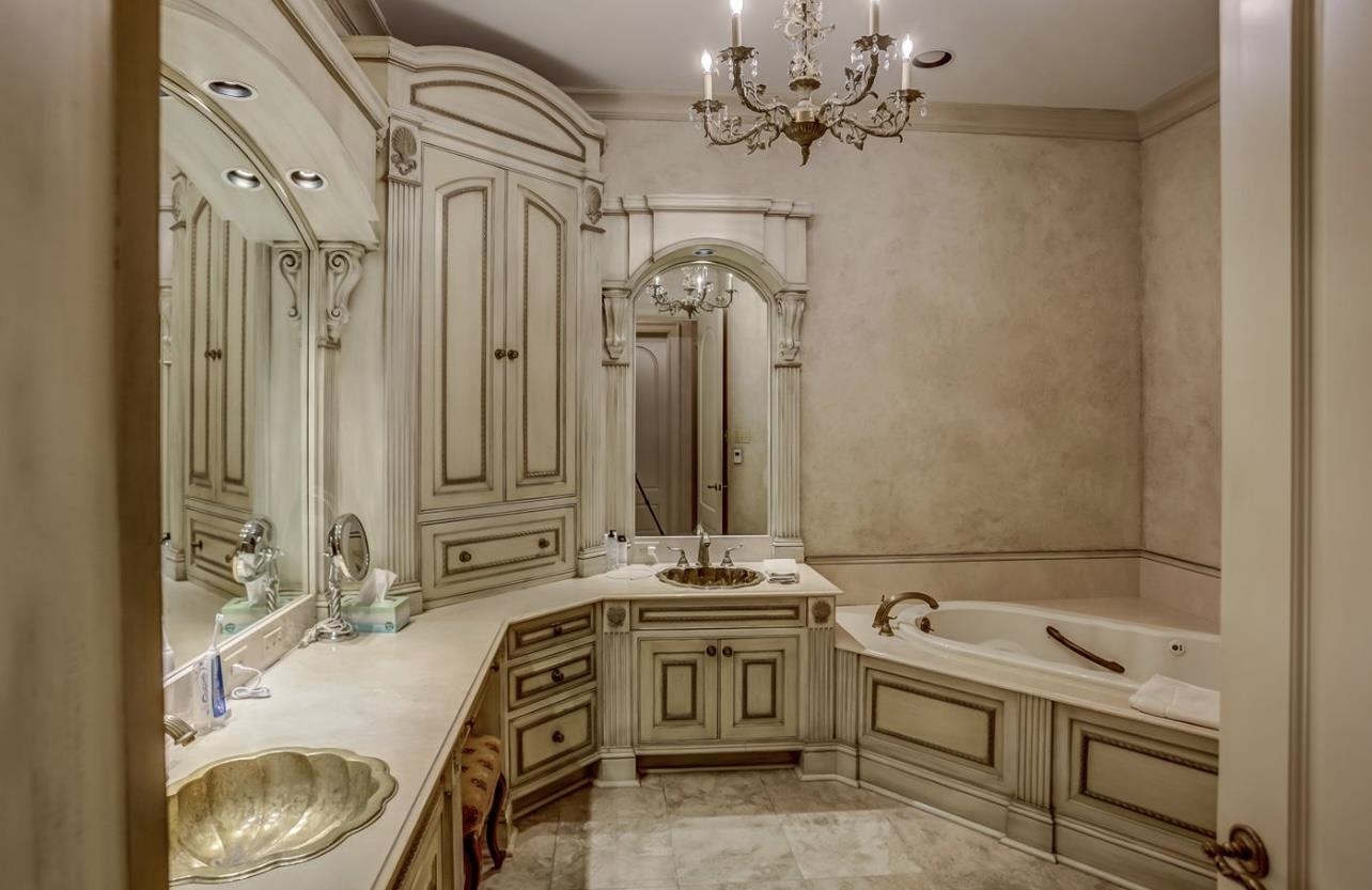 8575 The Island Memphis, TN 38125 - Photo 24 of 40 a bathroom with a sink a vanity and a mirror